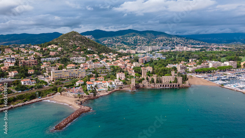 Aerial view of Château de la Napoule at the French Riviera. Photography was shot from a drone at a higher altitude from above the water wit the beautiful marina and beach in the view.