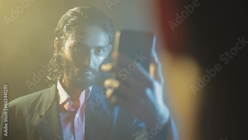 An intense scene set up between two gangsters looking at each other, late-night stories. Creative film-like footage with extraordinary lighting setting HD stock footage. photo