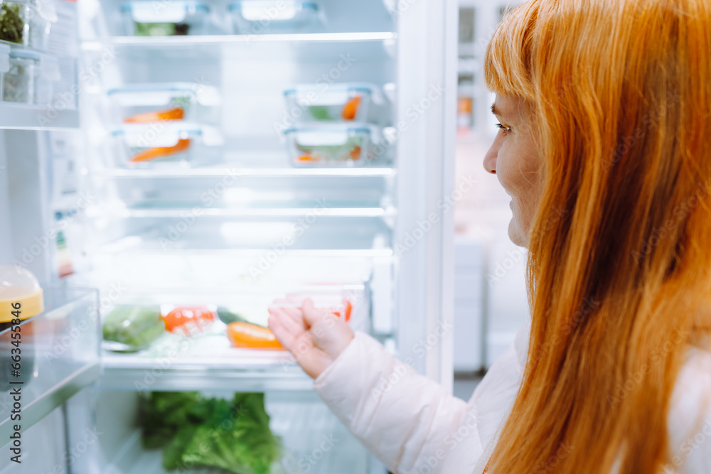 red-haired woman in store household appliances and kitchen utensils red-haired woman in store household appliances and kitchen utensils