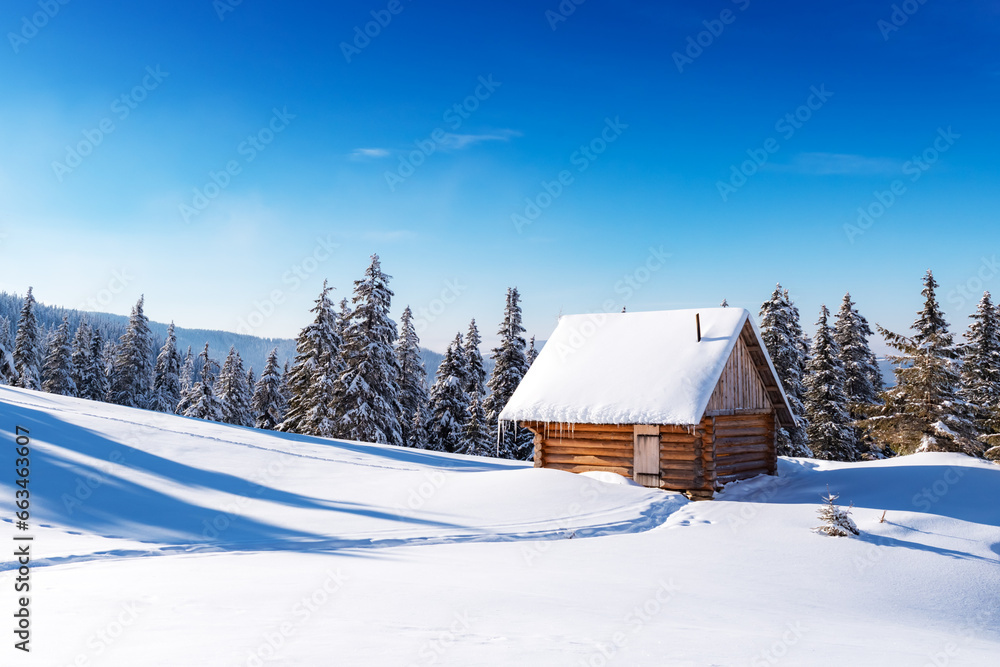 A wintery scene with a mountain meadow, snow-covered pine trees, and a rustic wooden cottage. Clear blue sky on background A wintery scene with a mountain meadow, snow-covered pine trees, and a rustic wooden cottage. Clear blue sky on background