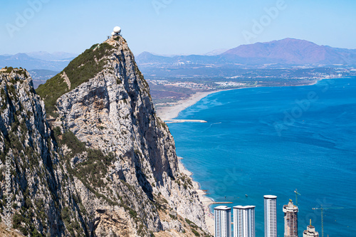 The top of the Rock of Gibraltar with the coastline and Alboran or Mediterranean sea in the background.