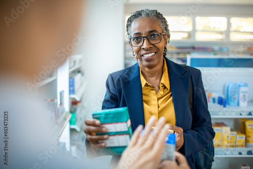 Senior businesswoman receiving advice from a pharmacist at the drugstore photo