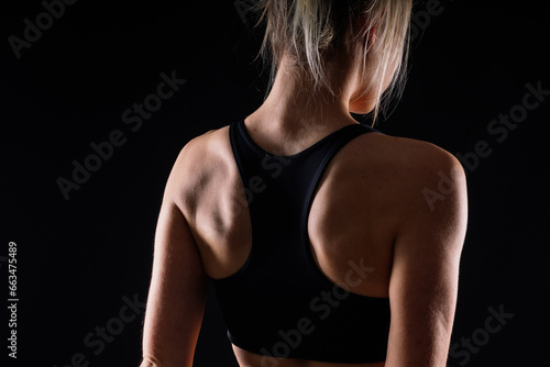 Beautiful young woman dressed in a sports uniform, posing in the studio. Healthy lifestyle, sport
