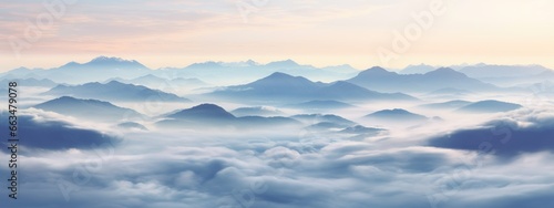 A breathtaking aerial view of majestic mountain peaks emerging above a sea of fluffy clouds
