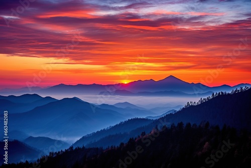Mountain range silhouetted against a vibrant sunset