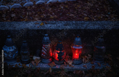 Votive candles lantern burning on the graves in Slovak cemetery at night time. All Saints' Day. Solemnity of All Saints. Hallows eve. 1st November. Feast of Saints. Hallowmas. Souls' Day in Slovakia