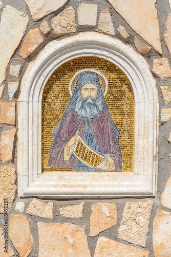 Representative figure of the Greek Orthodox Church of Ayia Napa.  mosaics outside the church.