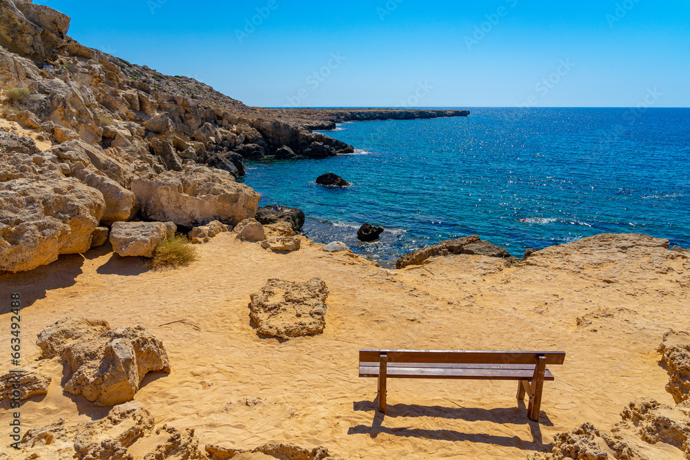 Wooden bench on the hillside facing the Mediterranean Sea for contemplation in Cape Greco. Captured in September 2023.