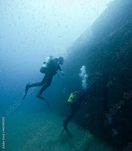 divers exploring a sunken ship