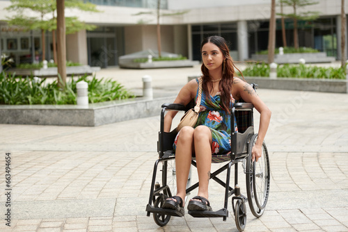College student moving around campus in wheelchair