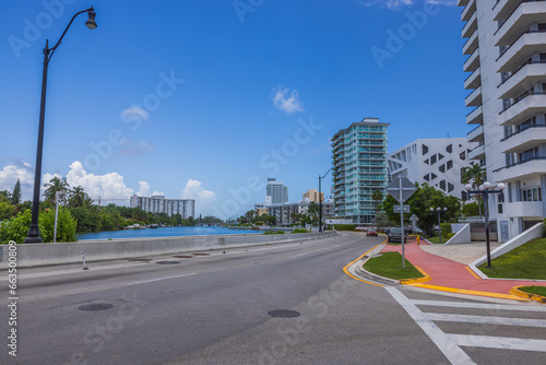Beautiful urban landscape of Miami Beach on sunny summer day. Road runs along waterfront with tall modern buildings on other side. USA. © Alex