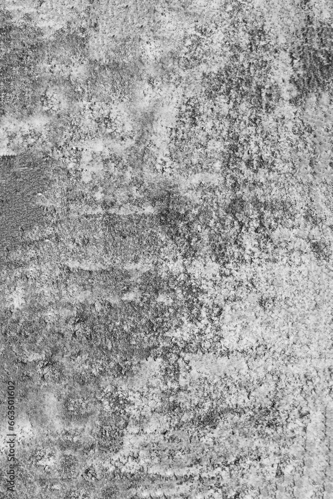 Fototapeta premium Vertical photo of an old, gray, concrete wall damaged by time.
