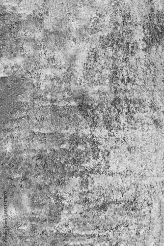 Vertical photo of an old, gray, concrete wall damaged by time.