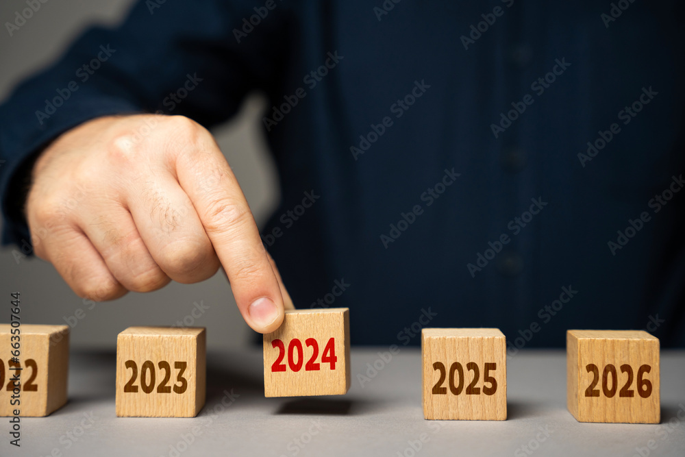 The coming of 2024. The man determines the next year. Reflecting on past achievements and experiences, looking forward. Embracing new trends, making forecasts, setting plans for coming future. The coming of 2024. The man determines the next year. Reflecting on past achievements and experiences, looking forward. Embracing new trends, making forecasts, setting plans for coming future.