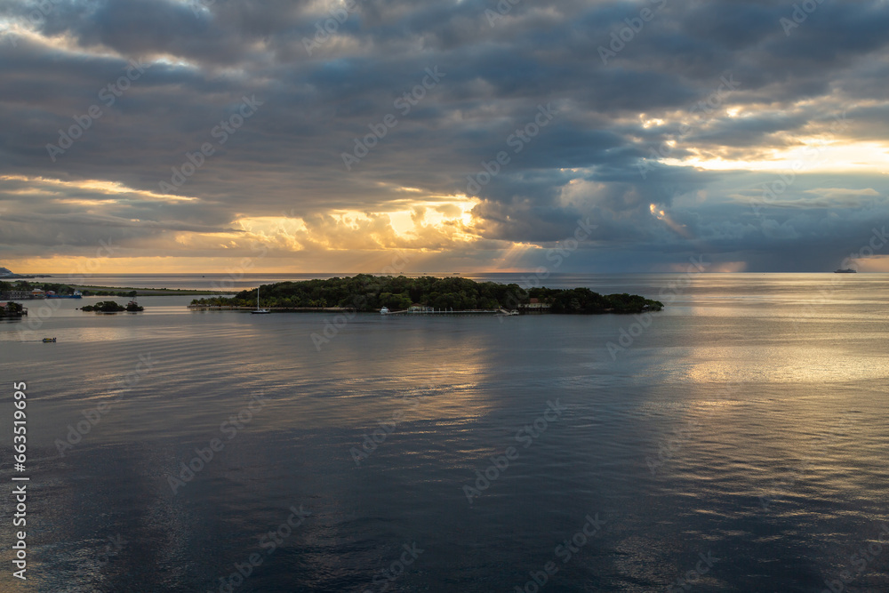 Exposure of the view of the beautiful port of Roatan, Honduras, in the Caribbean Bay, part of the huge Mesoamerican Barrier Reef, taken from a cruise ship at sunrise.