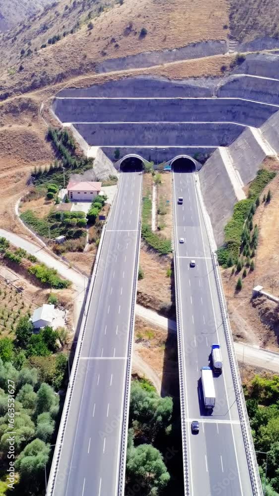 Aerial view of a amazing green landscape highway that runs through the mountains Aerial view of a amazing green landscape highway that runs through the mountains
