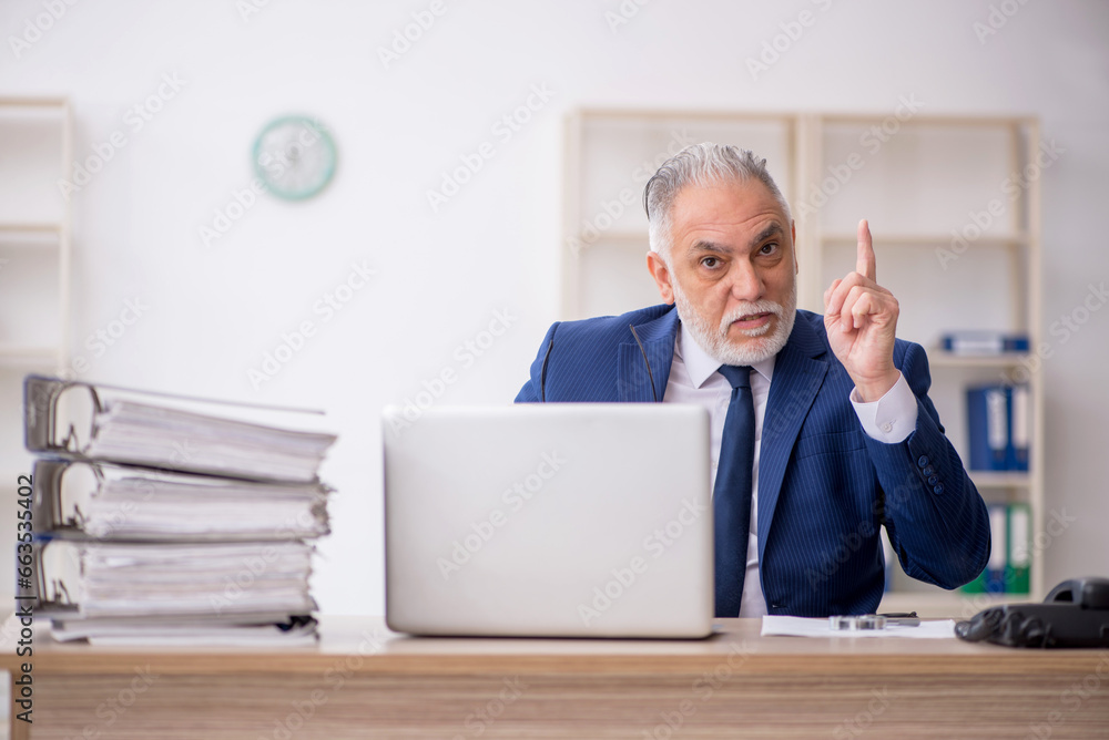 Old male employee and too much work in the office Old male employee and too much work in the office