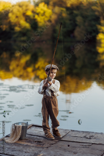 Child fishing at autumn lake