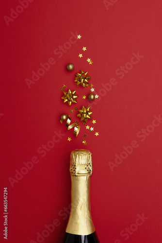 Champagne bottle with confetti stars on color background, space for text