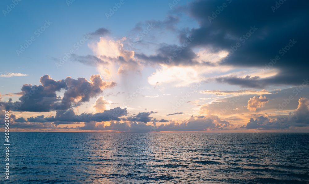 Sunset on sea. Beach sunrise with cloudy sky. Sunset on sea. Beach sunrise with cloudy sky.