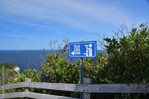 Blue sign indicating Land’s End location. Famous hiking trail in Forillon national Canada park. Lookout indication. photo