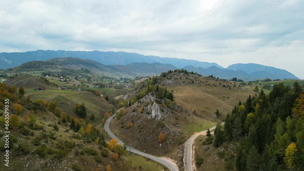 Autumn aerial view above colorful hills in village Sirnea, Transylvania. Rural landscape in the mountain area. Autumn landscape. Picturesque, colorful trees and rocky hills. Carpathians mountains Autumn aerial view above colorful hills in village Sirnea, Transylvania. Rural landscape in the mountain area. Autumn landscape. Picturesque, colorful trees and rocky hills. Carpathians mountains