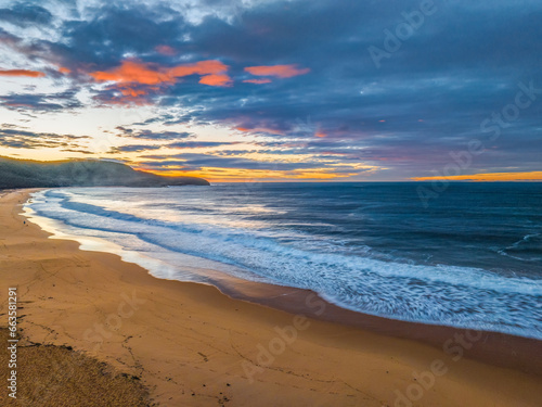 Surf, sea, sand, sunrise with clouds