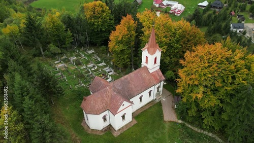 Aerial drone shot of rural catholic church in Sirnea (Șirnea) village near Brasov. Medieval catholic church in Romanian village. Transylvania. photo