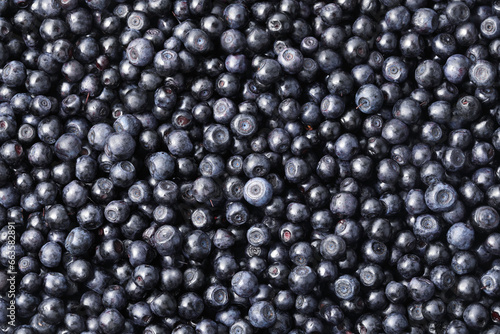 Many delicious ripe bilberries as background, top view