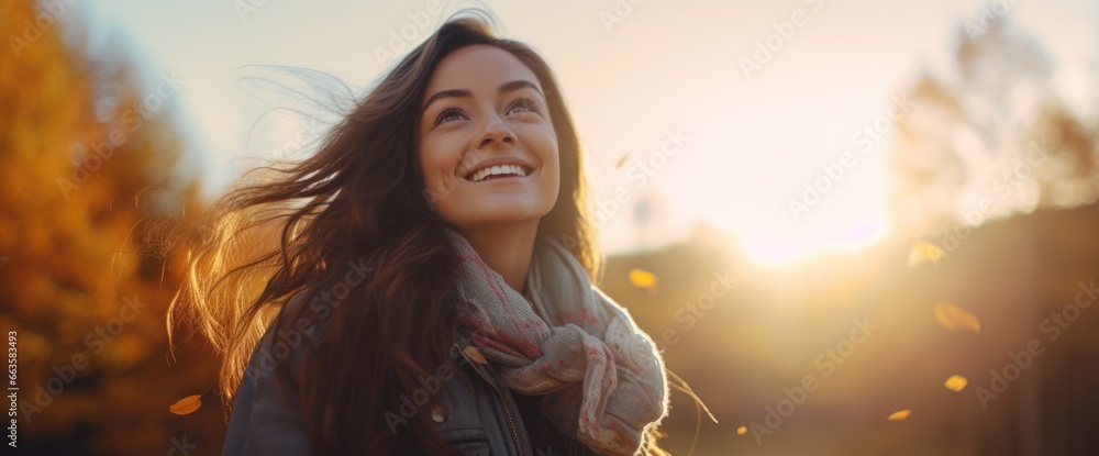 Fototapeta premium A woman smiling at sunset