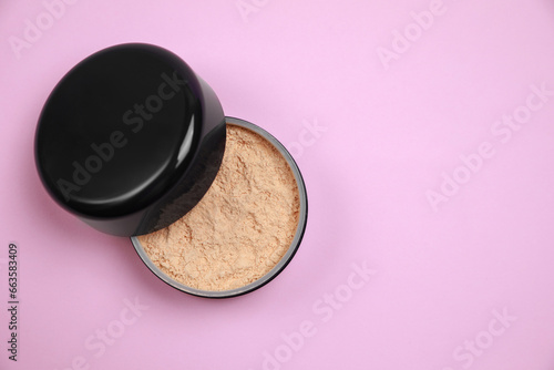 One face powder on pink background, top view with space for text