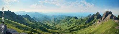 A majestic mountain range surrounded by vibrant green grass