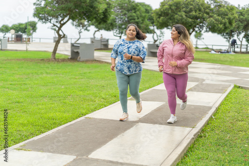 Overweight women jogging along an urban park
