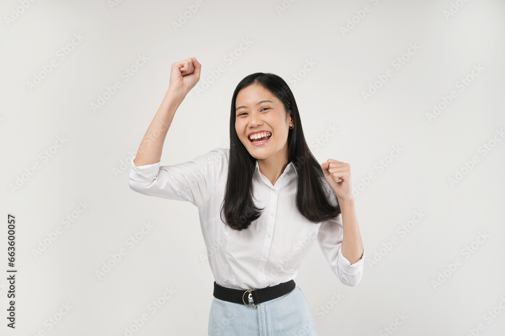The photo of a young Asian woman feeling excited about what she got, she wearing a white shirt and isolated on a white background. The photo of a young Asian woman feeling excited about what she got, she wearing a white shirt and isolated on a white background.
