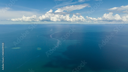 Surface of blue ocean with waves and blue sky with cloud. Borneo, Malaysia.