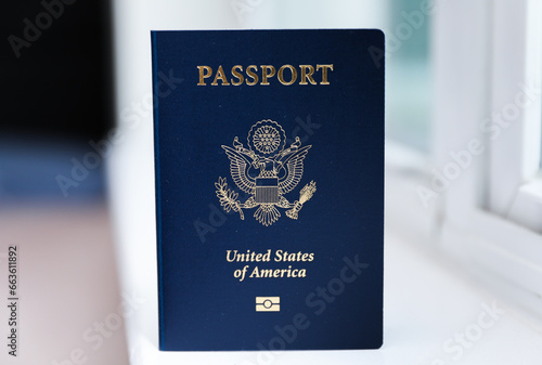 U.S. passport on a dark background, symbolizing travel, identity, citizenship, and international journeys, with patriotic colors and security features photo