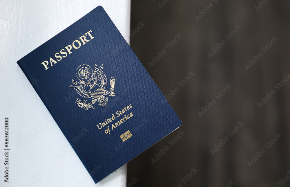 Fototapeta premium U.S. passport on a dark background, symbolizing travel, identity, citizenship, and international journeys, with patriotic colors and security features