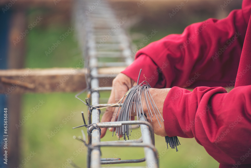 Construction Worker hands using pincer pliers iron wire. Outdoor Worker