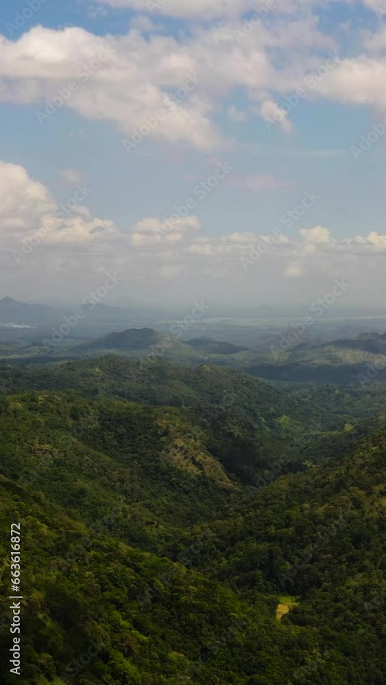 Gorge among mountains and hills covered with jungle and tropical forest. Mountain landscape in Sri Lanka. Gorge among mountains and hills covered with jungle and tropical forest. Mountain landscape in Sri Lanka.