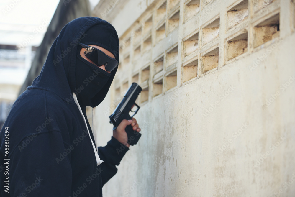 Terrorist war criminal men make a crime thief in black dress head shot. Bad anonymous soldier army with gun weapon in hand mafia attack. kidnap illegal bandit murderer. Criminal terrorist war concept Terrorist war criminal men make a crime thief in black dress head shot. Bad anonymous soldier army with gun weapon in hand mafia attack. kidnap illegal bandit murderer. Criminal terrorist war concept