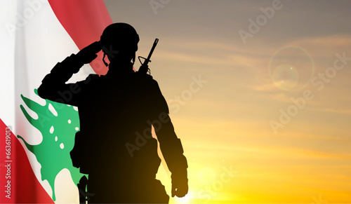 Silhouette of a soldier with Lebanon flag against the sunset. EPS10 vector