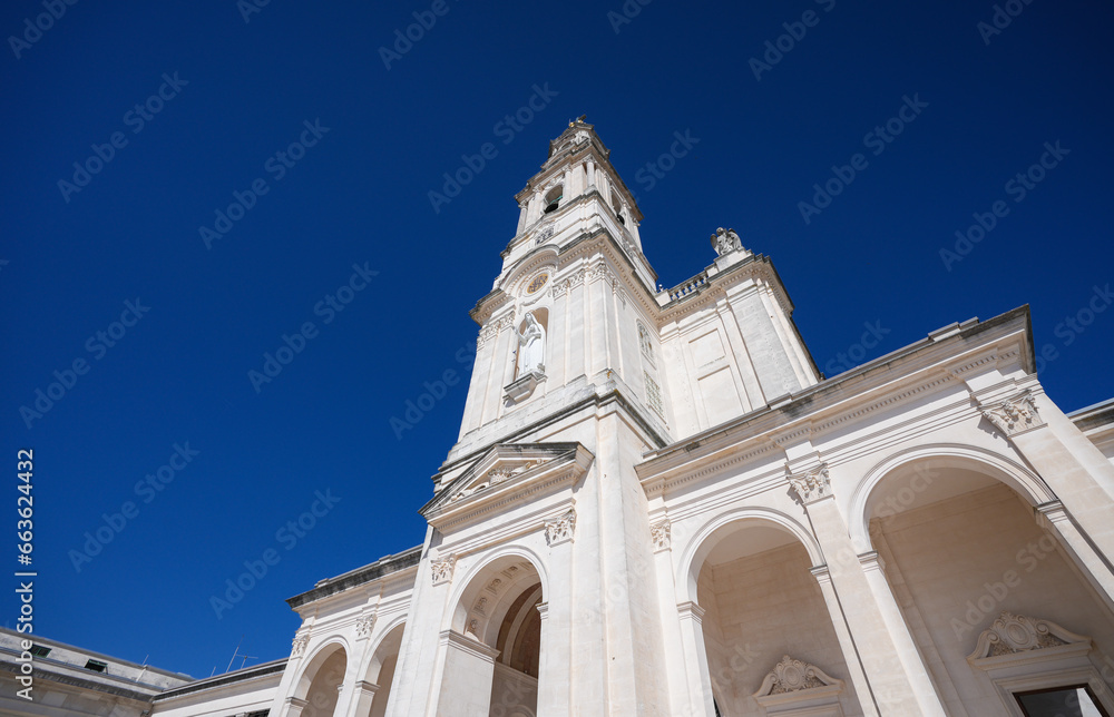 Fatima Church basilica. The miracle place church from Fatima, Portugal, against blue clean sky, while the bells are ringing. Religious landmark monastery from Portugal.