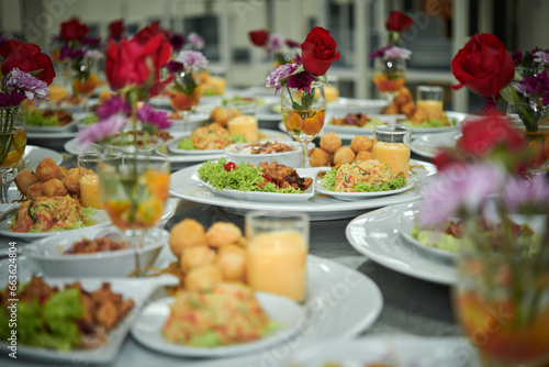 Many plates of catering food for an event