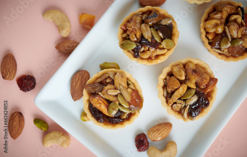 Canvastavla Appetizing tartlets stuffed with hazelnuts walnuts covered with a layer of liquid caramel