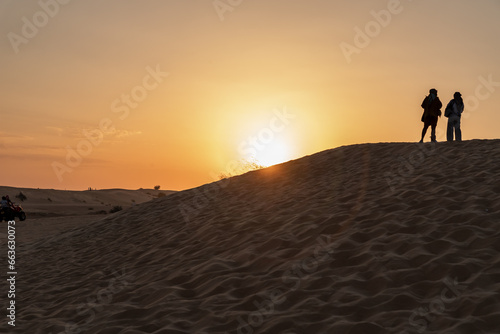 The sunset in the sandy desert near Dubai city, United Arab Emirates