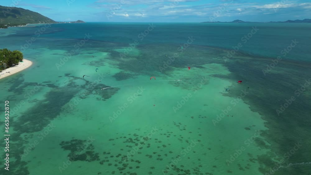 Drone shot of kite surfers in the clear waters of Koh Phangan Thailand Drone shot of kite surfers in the clear waters of Koh Phangan Thailand