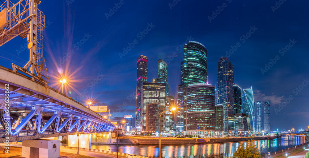 The scyscrapers of the Moscow City at night and the Dorogomilovsky bridge with illumination. Translation of text - street names: Krasnopresnenskaya, center, etc.