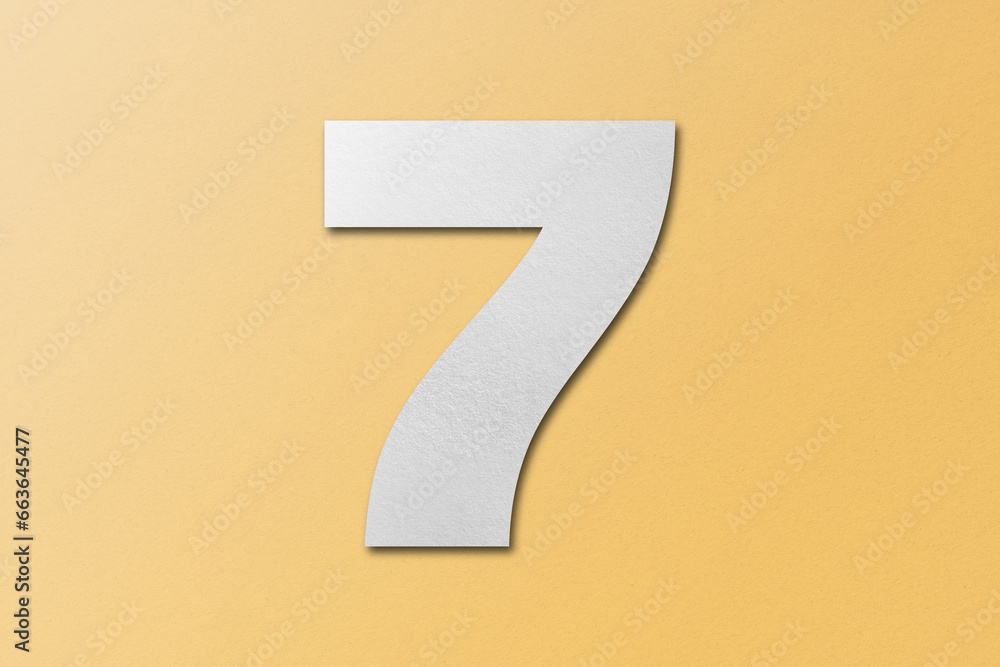 White paper font number 7 isolated on orange background. White paper font number 7 isolated on orange background.
