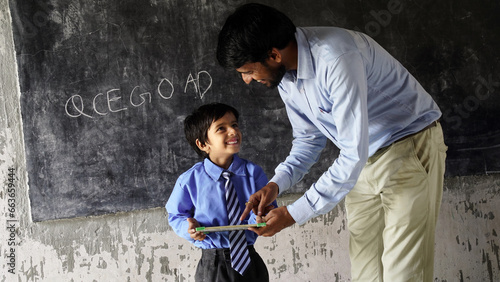 Young male lecturer helping student during his class. Student in a lecture with helpful teacher.