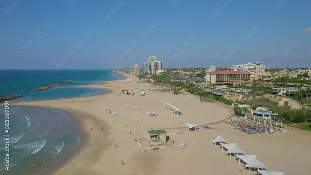 Acadia South Herzliya beach - the beach is empty of visitors on a hot sunny day, The beach is right next to the Marina and includes accessible paths leading all the way to the waterline